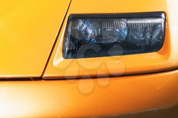 Headlight design on a luxury yellow sports car 