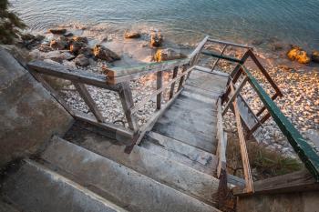 Perspective view of old wooden stairs going down to the beach. Zakynthos island, Greece