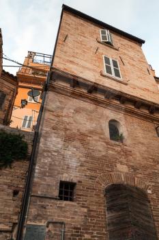 Old stone houses facades of Fermo, Italy