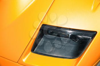 Headlight of luxury yellow roadster, Italian car design