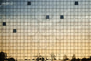 Modern office building wall made of glass with open windows and reflections, abstract background photo texture