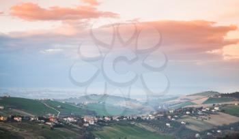 Italian countryside, rural landscape. Province of Fermo, Italy. Villages on hills under colorful morning sky