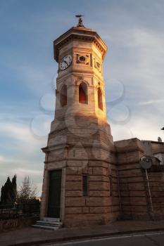 Fermo town, Italy. Old clock tower in evening sunlight, Italy