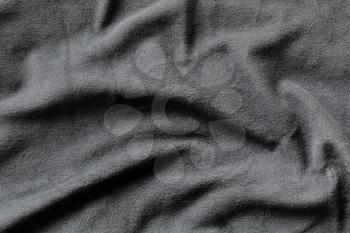 Texture of gray fleece, soft napped insulating fabric made from polyester, wavy pattern