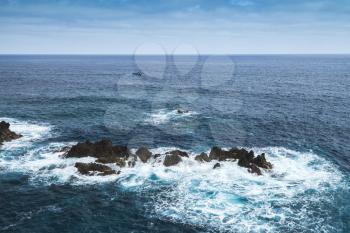 Coastal rocks in ocean water. Porto Moniz, Madeira island, Portugal
