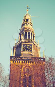 Exterior of Oude Kerk, the oldest building in Amsterdam. Vintage toned photo with retro tonal correction filter