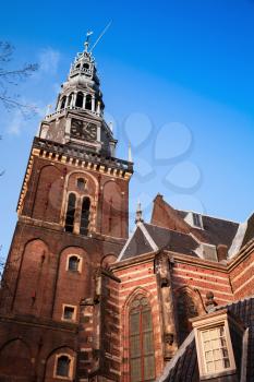 Exterior of Oude Kerk, the oldest building in Amsterdam. The church was consecrated in 1306 by the bishop of Utrecht