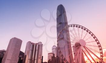 Evening cityscape of Hong Kong, Victoria tower and Ferris wheel under colorful sky