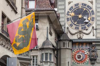 Fragment of the Zytglogge clock tower with flag of Bern, Switzerland