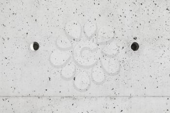 Gray concrete wall with holes, close-up background photo texture