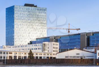 Cityscape of Reykjavik, capital city of Iceland. Street view with modern buildings and crane