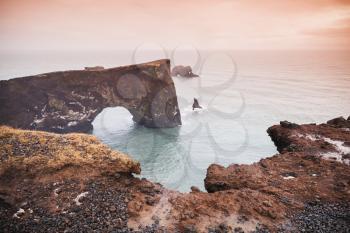 Scenic landscape with natural stone arch. Dyrholaey Nature Reserve, south coast of Iceland, Europe