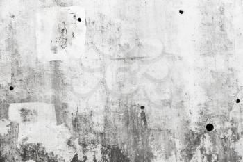 Grungy gray concrete wall with white paint brush strokes, background texture