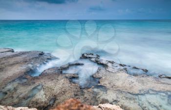 Mediterranean Sea rocky coast. Long exposure photo with natural blur effect of water. Summer morning landscape of Ayia Napa, Cyprus island