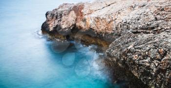 Coast of Mediterranean Sea. Long exposure photo with natural blurred water effect. Summer morning landscape of Ayia Napa, Cyprus island