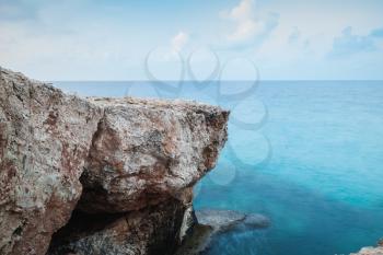 Mediterranean Sea coastal rocks. Long exposure photo with natural blurred water effect. Summer morning landscape of Ayia Napa, Cyprus island