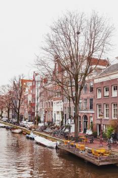 Canal street view. Autumn in Amsterdam, Netherlands. Vertical photo