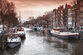 Canal perspective, street view of Amsterdam, Netherlands. Warm gradient tonal correction filter effect