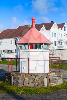 Coastal Norwegian lighthouse. Small white tower with red top. Haugesund, Norway