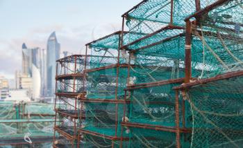 Traps for crabs lay in fishing port of Busan, South Korea. Boxes with green net