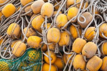 Pile of drying fishing nets with yellow floats. Background photo