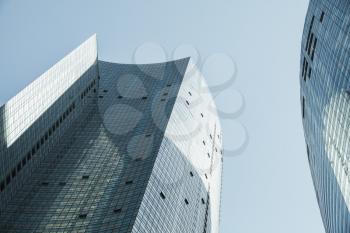 Abstract modern architecture background photo, tall office towers made of glass and steel under blue sky