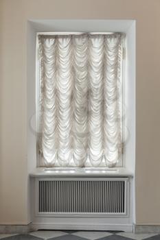 Empty window covered with white tulle, classic interior background photo