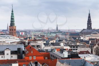 Cityscape of Copenhagen with spire of City Hall. Photo taken from The Round Tower, popular old city landmark and viewpoint. Denmark