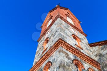 Bell tower of Juva Church under blue sky in summer day. Finland