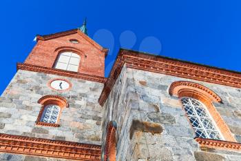 Facade of Juva Church under blue sky in summer day. Finland