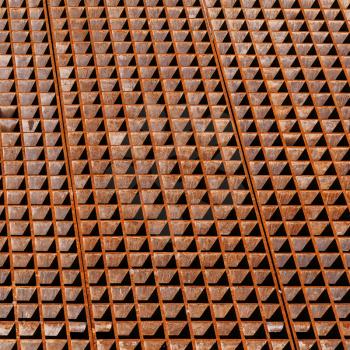 Rusty industrial floor with drainage grate sections, background texture