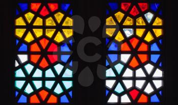Stained glass window with geometric Arabic pattern, background photo texture 