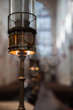 Lamp with candle, interior of Bath Abbey, Somerset, UK