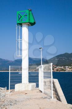 Modern white lighthouse tower with green top in Port of Propriano, South region of Corsica island, France