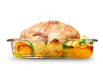 Whole chicken baked with potatoes and greens isolated on white