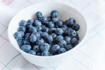 Blueberries in white bowl on the table