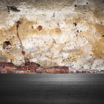 Grunge city background with old brick wall and asphalt