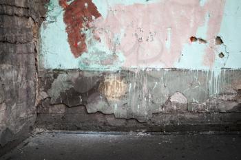 Corner of an abstract empty abandoned urban interior fragment, old colorful wall and asphalt road