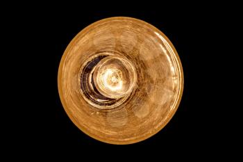 Incandescent light bulb in the round lampshade isolated on black background