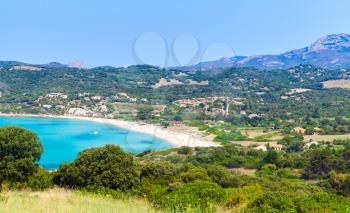 Summer coastal landscape of Corsica island. Small azure bay with beach. Piana region, France