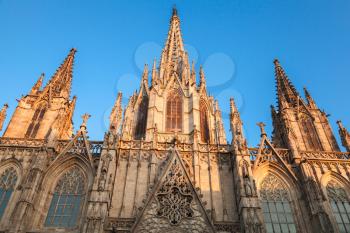 Cathedral of the Holy Cross and Saint Eulalia or Barcelona Cathedral. Facade in warm evening sunlight