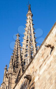 Cathedral of the Holy Cross and Saint Eulalia also known as Barcelona Cathedral. Roof fragment with spires over blue sky