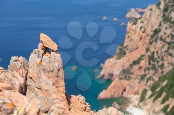 Rocks and sea in hot summer time. Landscape of French mountainous Mediterranean island Corsica. Corse-du-Sud, Piana region. Photo with selective focus
