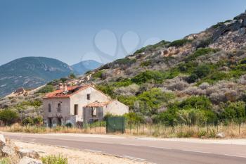 Rural landscape of South Corsica with old abandoned stone house near a highway, Piana region, France