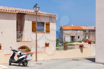 Street view of Piana town in bright summer day. Corsica island, France
