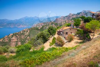 Rural landscape with stone house on rocky coast. Piana region, South Corsica, France