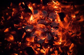 Red burning coals dark abstract background