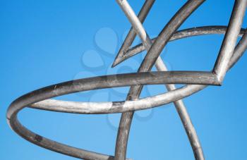 Abstract metal tubes construction in front of clear blue sky