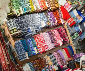 RIGA, LATVIA - DECEMBER 2013: Colorful woolen mittens with traditional folk patterns on the street counter on December 31, 2013. This is a popular Latvian handcraft souvenirs