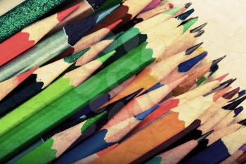 Set of colorful pencils and old paper. Vintage toned photo filter effect 